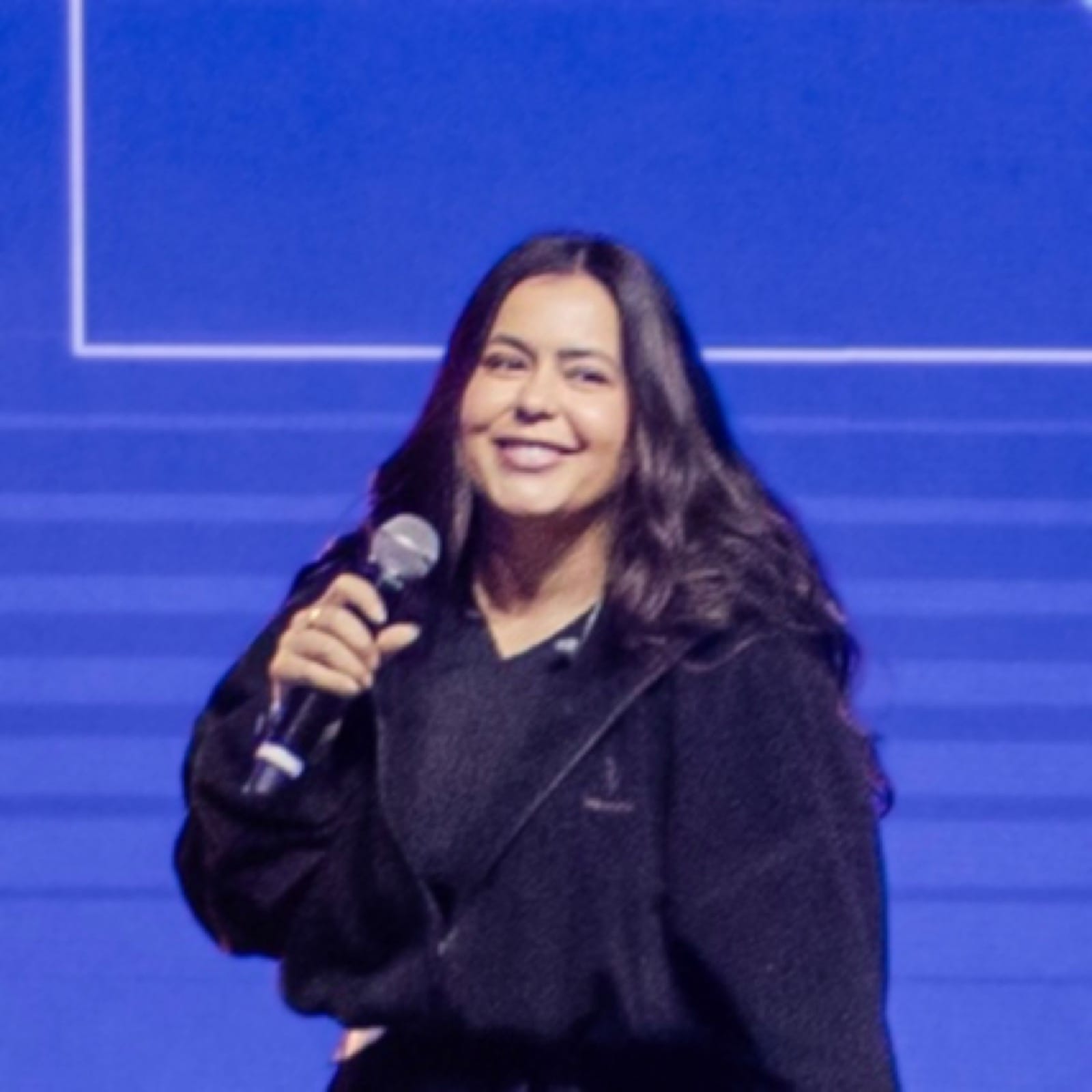 Ivy smiling while speaking on stage